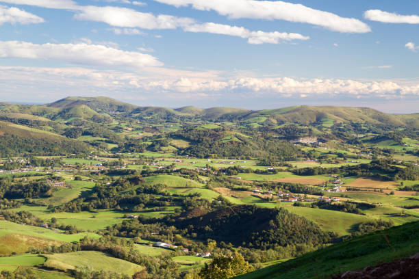 A beautiful day for this amazing view across the Pyrenees Mountain Ranges Blue skies, green grass and perfect conditions for the first day of the Camino Santiago in France heading over the border into Span saint jean pied de port stock pictures, royalty-free photos & images