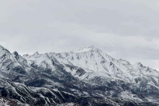 istock snow on mountain peak in cloudy day 868457784