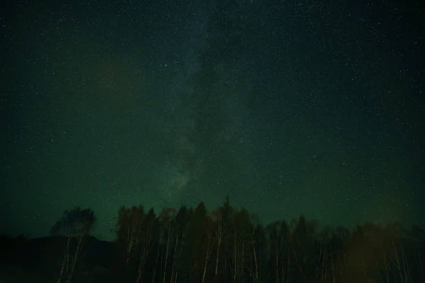 istock Night sky over rural landscape. Beautiful night starry sky 868457848