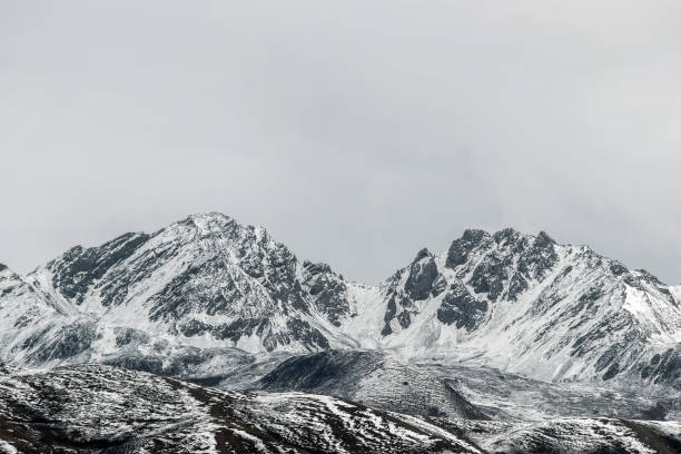 istock snow on mountain peak in cloudy day 868457934