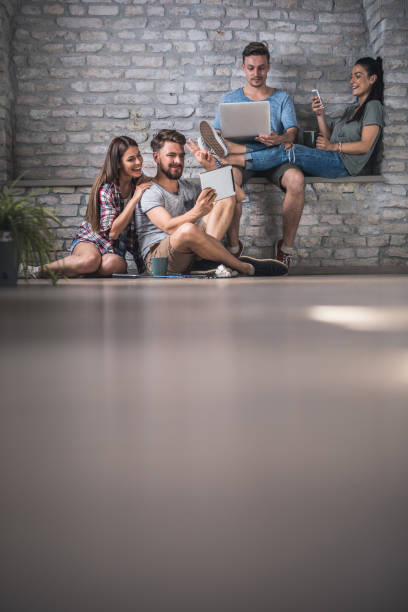 istock Group of young happy adults using wireless technology. 868462250