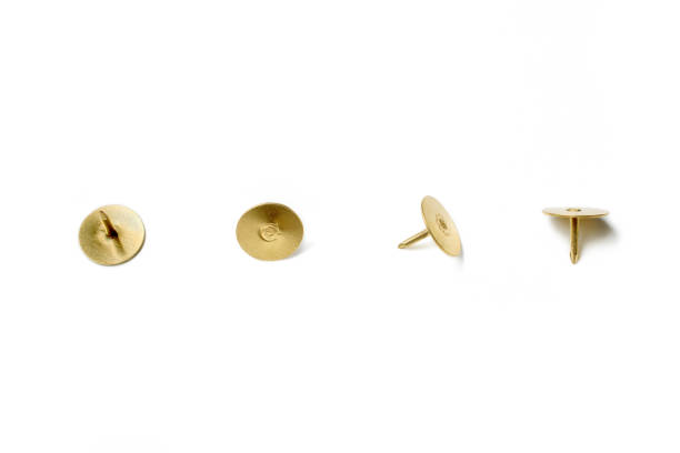 istock Small Collection Of 4 Brass Thumbtacks Arranged In A Line On White Background 868462618