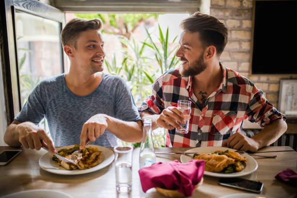 istock Young happy men communicating during lunch time at home. 868465186