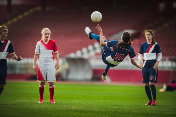 istock Skillful female soccer striker doing bicycle kick during the game. 868465848
