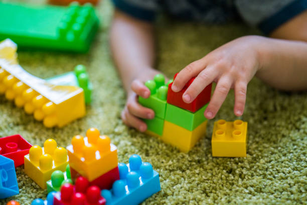 istock Close up view kids hands playing with plastic blocks 868466542