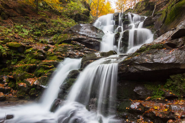 istock Autumn waterfall in forest landscape 868469686