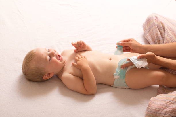 istock mom change baby diaper 868470052