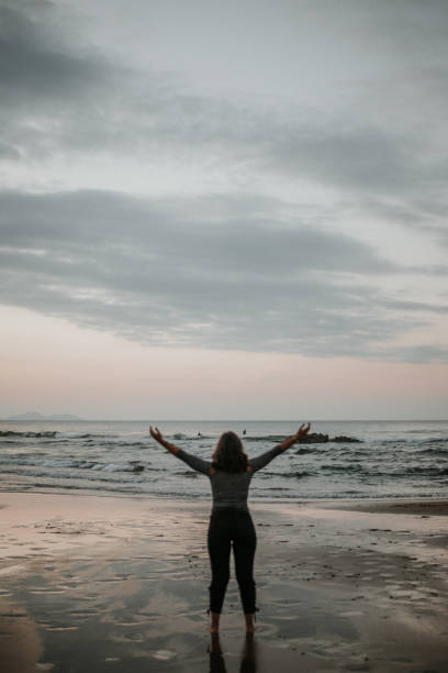 istock Young woman with arms raised 868470064