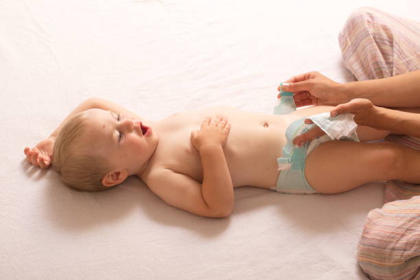 istock mom change baby diaper 868470122