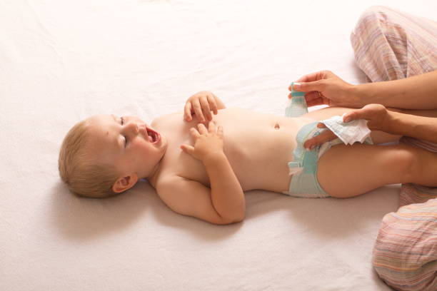 istock mom change baby diaper 868470196