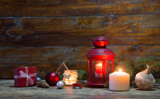 istock christmas Lantern with decorations on blue wooden background 868470288