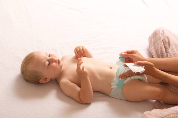 istock mom change baby diaper 868470374