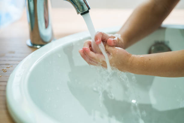 istock Children hands in running water 868470492