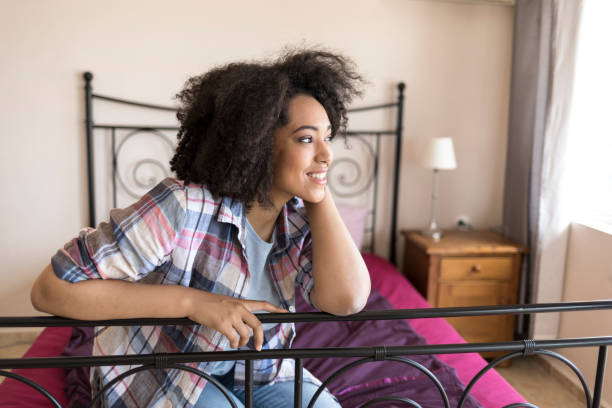 istock Beautiful african woman on bed 868473564