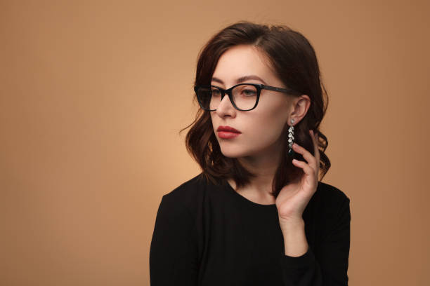 istock Stylish woman in glasses posing confidently 868475018