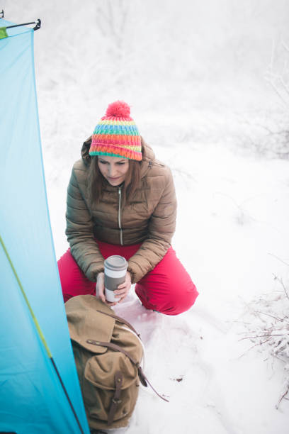 istock Woman inside tent set in winter hiking 868478484