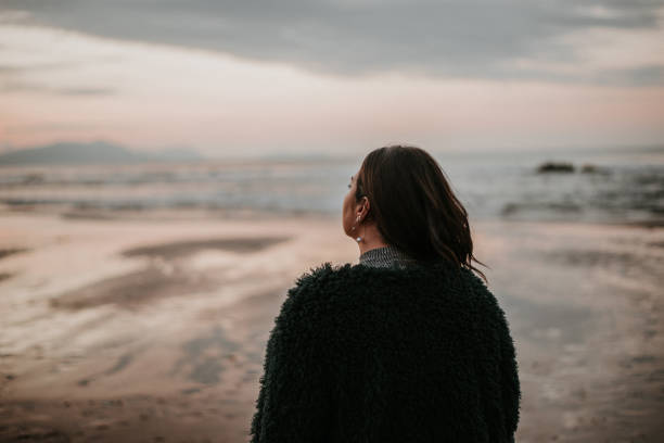 istock Beautiful woman by the ocean 868478568