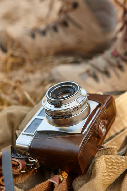 istock Vintage camera with hiking boots on the ground. Travel 868481538