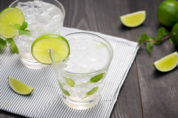 istock Fresh cocktail with lime, ice and mint on a rustic background. Copy space, top view 868481882