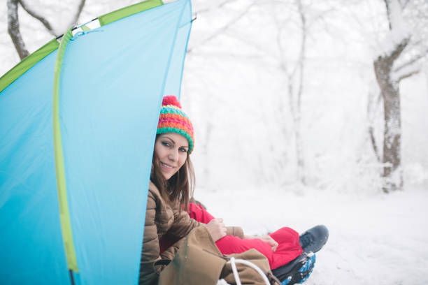 istock Woman inside tent set in winter hiking 868482150