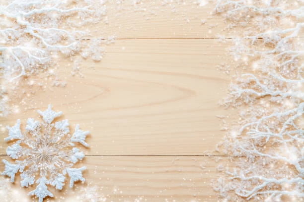 istock White frosty branches, covered with snow, white snowflake and copy space on horizontal unpainted wooden planks. 868483632