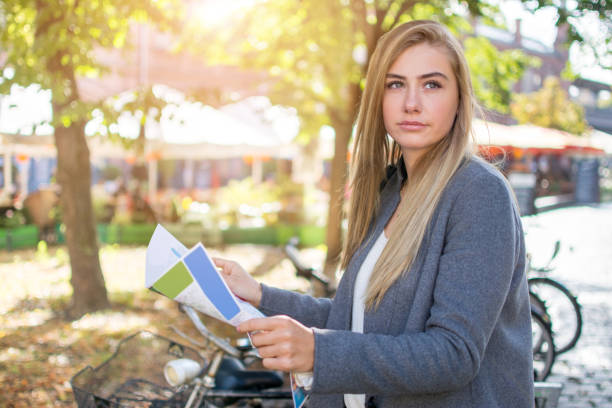 istock Young tourist woman with map exploring city streets. 868483798