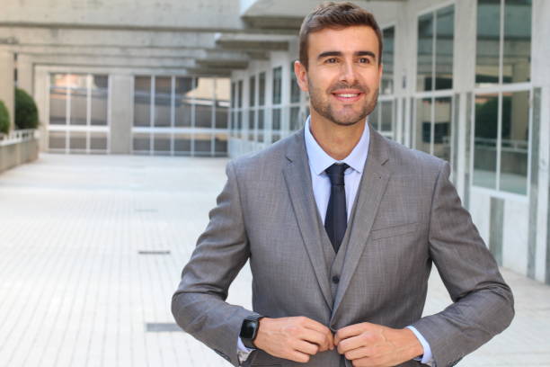 istock Elegant businessman adjusting his suit 868483812