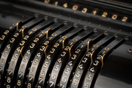 Details of a black mechanical calculator from the 19th century