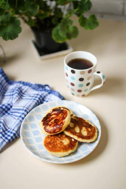 istock Homemade syrniki. Scandinavian kitchen interior and geranium 868488054