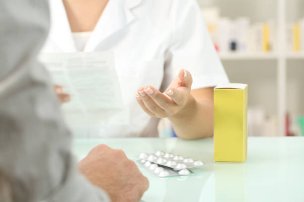 istock Pharmacist reading leaflet of a medicine to a patient 868488076