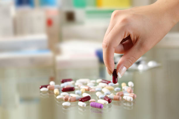istock Woman hand catching a pill from a group 868490508