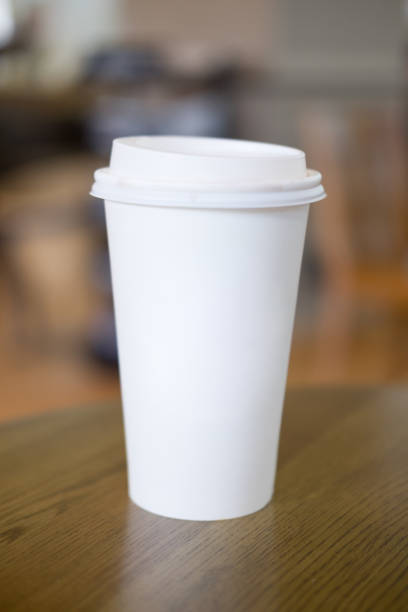 istock Coffee in a white paper cup on wood table 868490514
