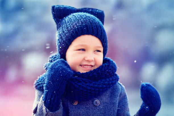 istock cute kid having fun under the winter snow 868491492