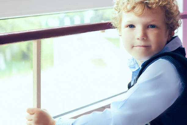istock Primary school student standing near the school window. 868491926