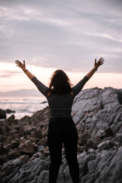 istock Young woman with arms raised 868497388