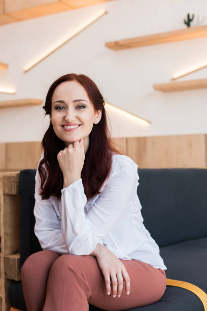 istock woman sitting on couch 868502828