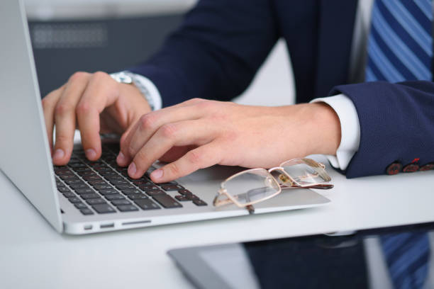 istock Businessman working by typing on laptop computer. Man's hands on notebook or business person at workplace. Employment  or start-up concept 868503556