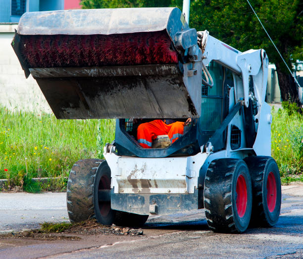 istock Sweeper attachments mini excavator. The sweeper sweeps, collects and dumps dirt and debris. 868507834