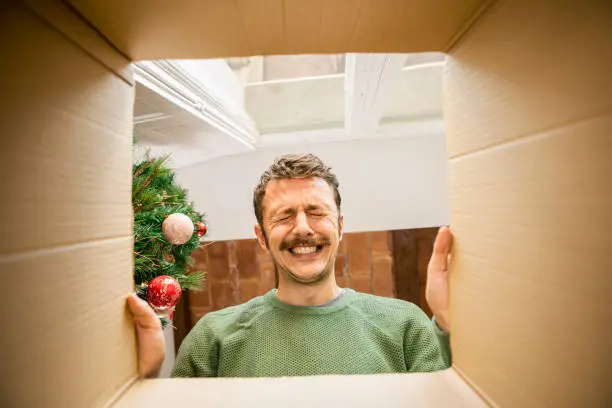 Photo of Man opening Christmas present