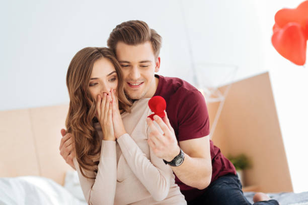 istock Amazed girlfriend looking at proposal ring held by boyfriend 868515034