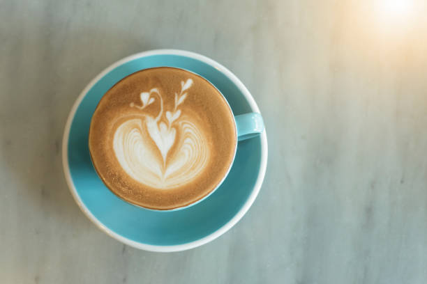 istock closeup hot coffee latte art cup on table. 868515120