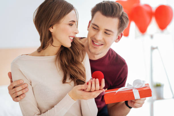 istock Loving boyfriend surprising his girlfriend with proposal 868515780