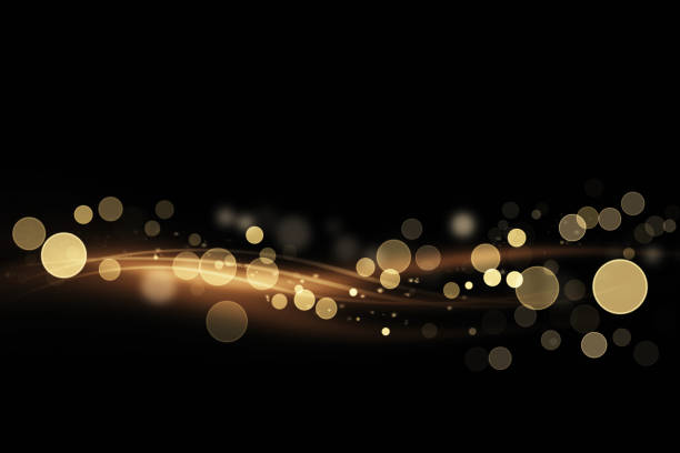 istock Abstract shiny color gold light wave design element with glitter bokeh effect on dark background. 868519788