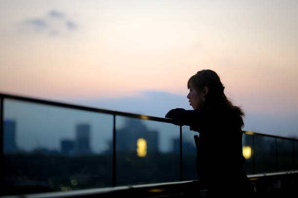istock Beautiful woman enjoying sunset view 868519982