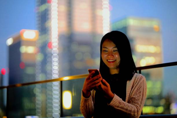 istock Young woman using mobile phone at terrace 868520090
