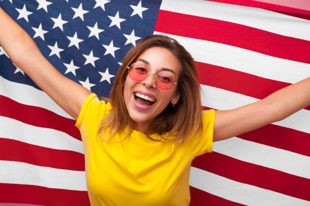 istock Happy model in sunglasses posing with flag 868520380