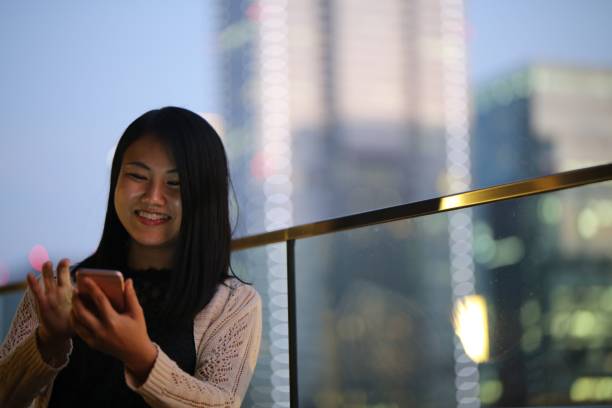 istock Young woman using mobile phone at terrace 868522306