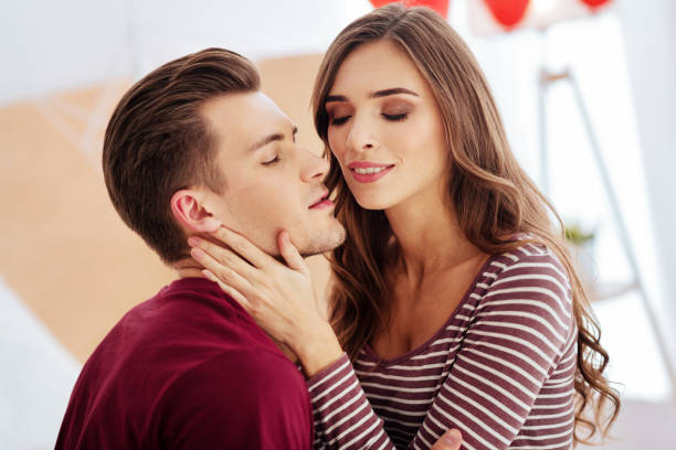 istock Romantic young couple kissing at home 868522478