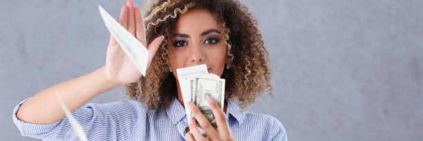 istock Beautiful black woman portrait. Scattering money notes 868530184