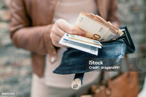 Woman Holding In Hands Wallet With Euro Money City Girl Is Taking Out Money From Wallet Stock Photo - Download Image Now